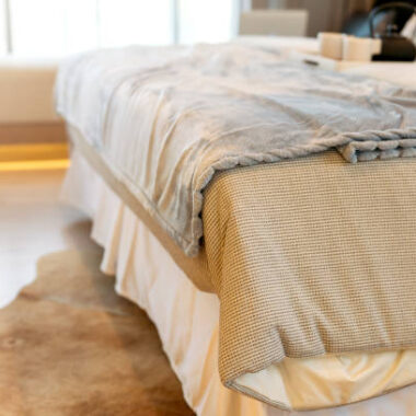 Beige color domestic carpet texture with light spot from window curtain