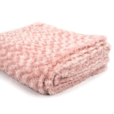 Pink folded blanket on a white background