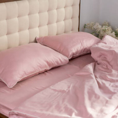 Pale pink satin bed linen and pillows morning messy