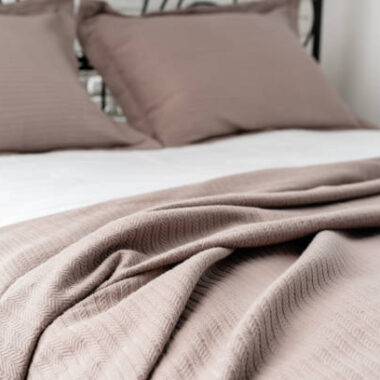 A black metal bed frame with ornate details stands in a modern bedroom.
