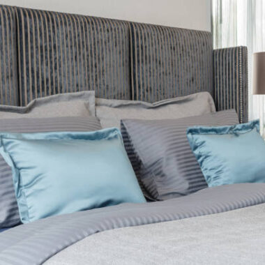 Modern bedroom with black color bed tone and set of pillows, interior design
